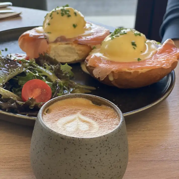 Eggs Benedict with salmon and a flat white